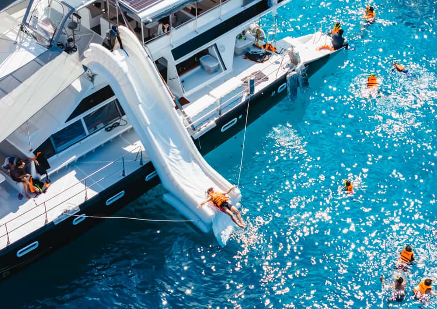 Phuket: Coral, Racha, Promthep Island Party Catamaran trip - Coral Island stop: beach time, swimming, and optional water sports